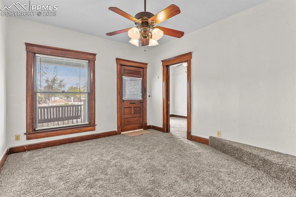 Image 12 of 30: Spare room with carpet and ceiling fan