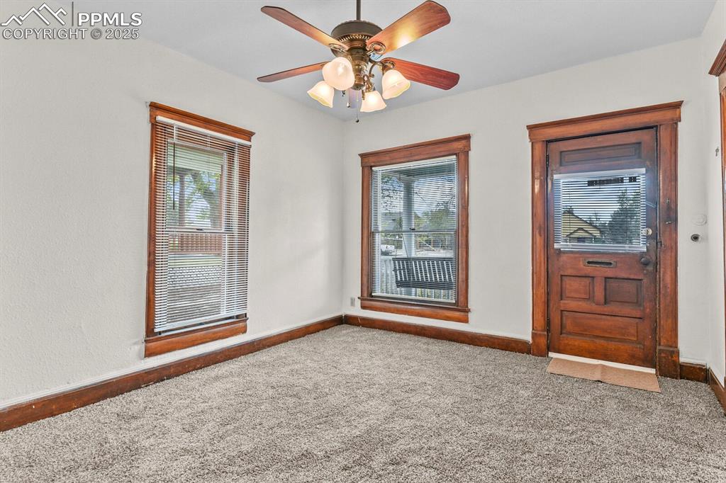 Image 13 of 30: Carpeted foyer featuring plenty of natural light and a ceiling fan