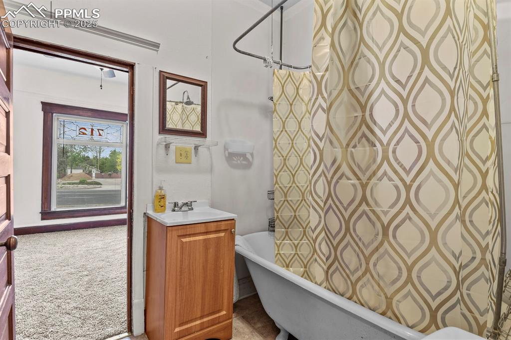 Image 18 of 30: Full bath featuring vanity and a combined bath / shower with freestanding t