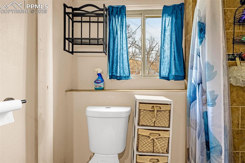 Image 17 of 29: Full bath with toilet and a shower with shower curtain