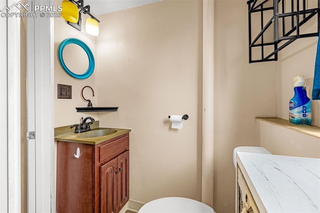 Image 18 of 29: Half bathroom featuring toilet and vanity