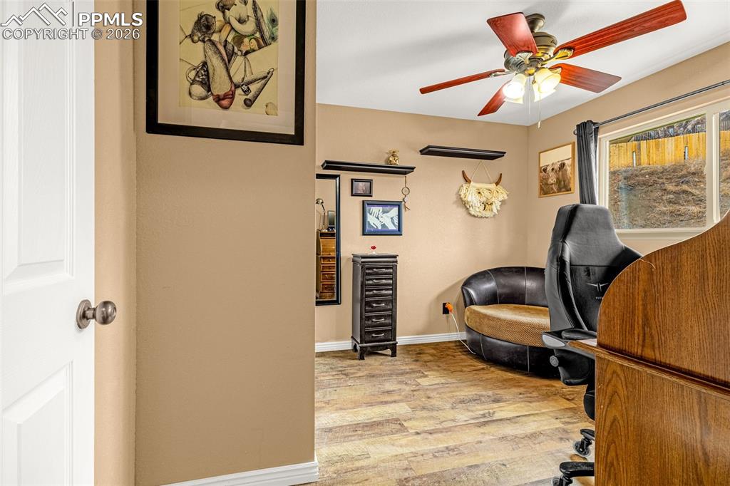 Image 22 of 29: Office with light wood-style flooring, a ceiling fan, and wine cooler