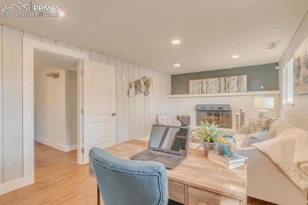 Image 10 of 47: In lower level, den with fireplace.