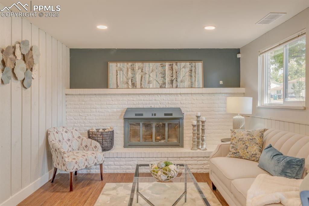 Image 23 of 47: Den with brick fireplace.