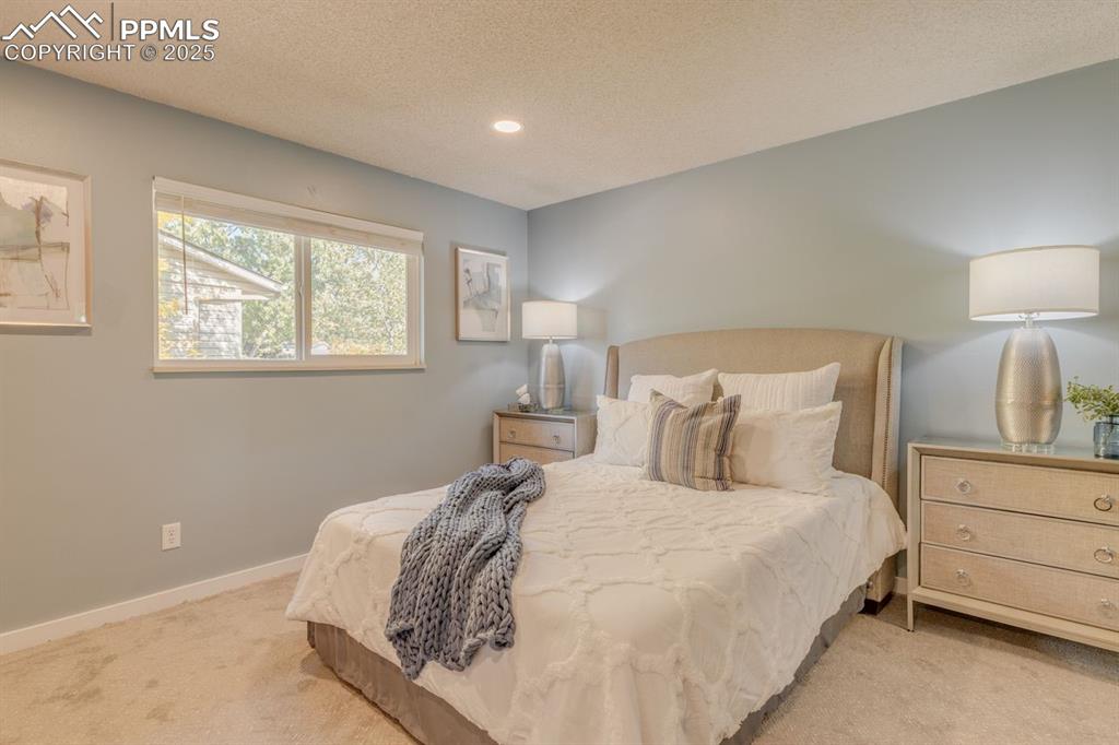 Image 29 of 47: Primary bedroom with recessed lighting.