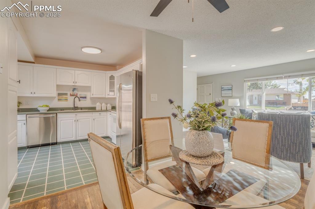Image 3 of 47: Dining area looking into the kitchen and livingroom.
