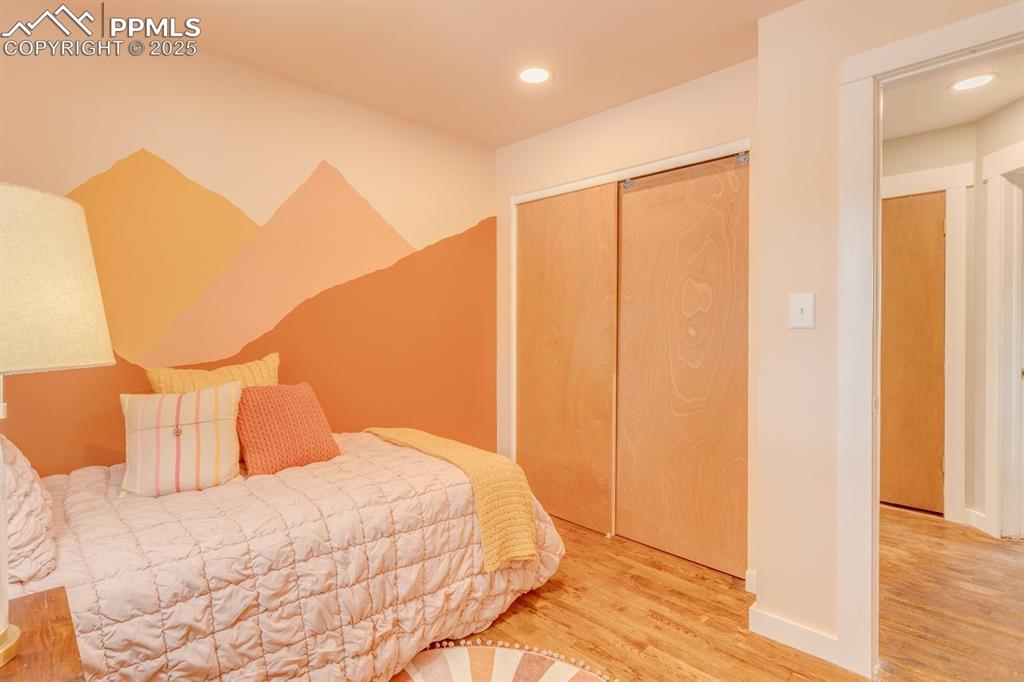 Image 30 of 47: Primary bedroom with recessed lighting.