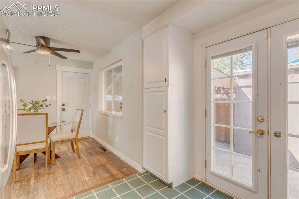 Image 32 of 47: Dining area conveniently located from the kitchen and the french doors lead