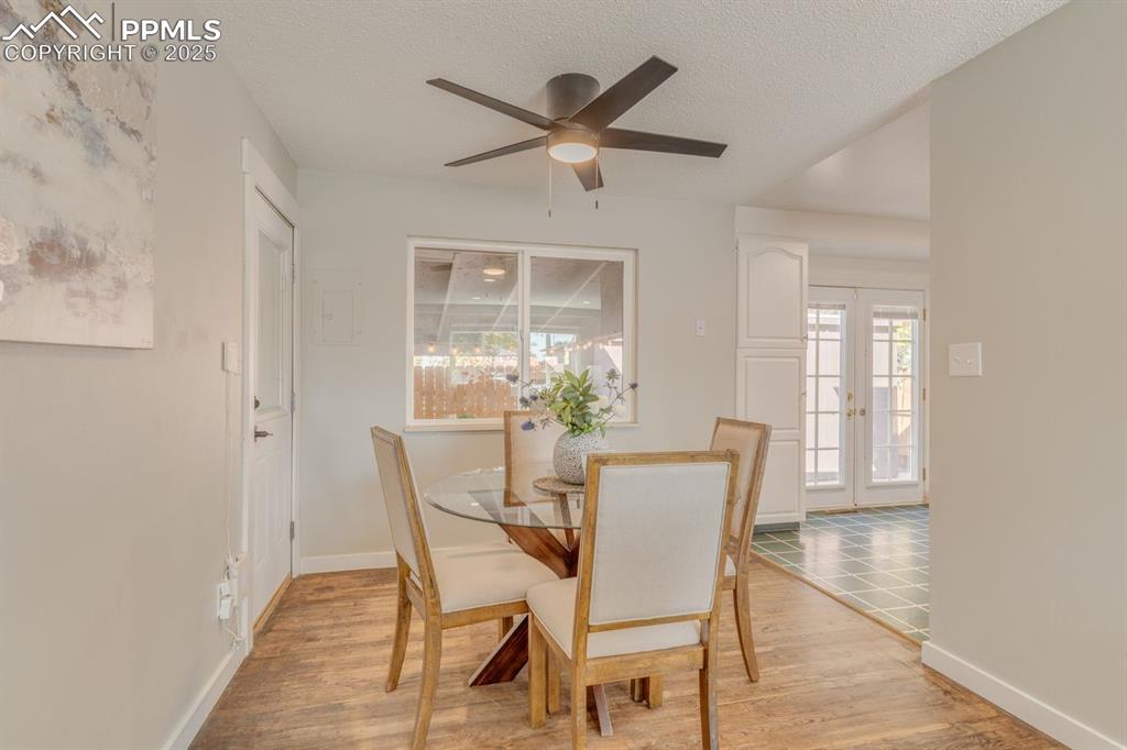 Image 36 of 47: Dining room with ceiling fan.