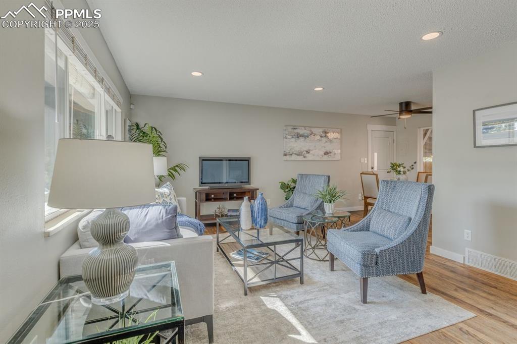 Image 38 of 47: Living area featuring wood finished floors, recessed lighting, and ceiling