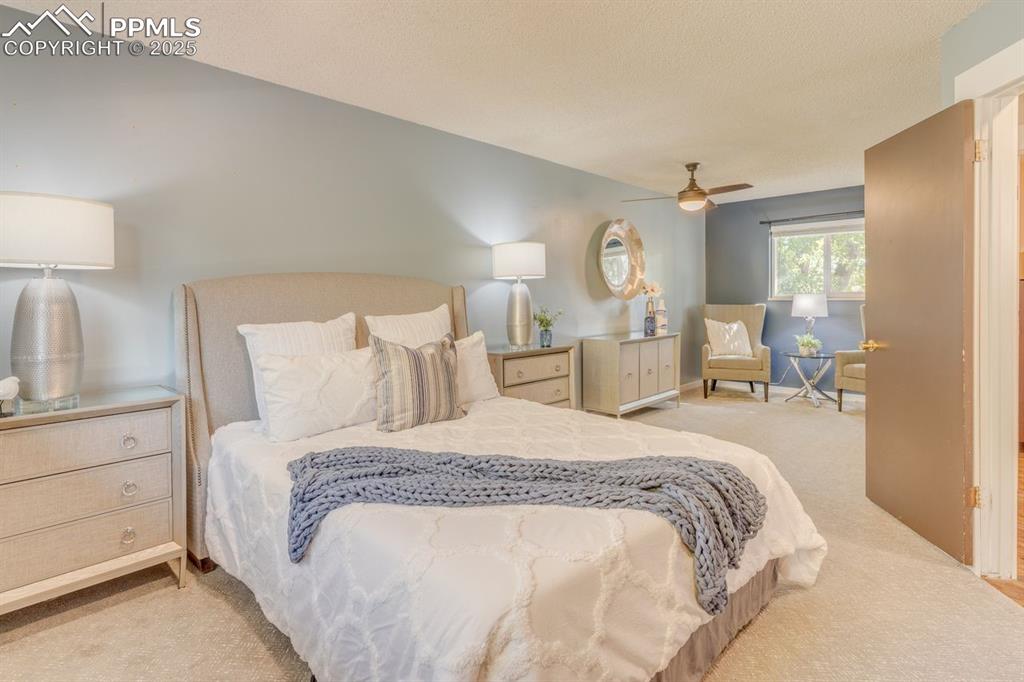 Image 4 of 47: Primary bedroom with sitting area.