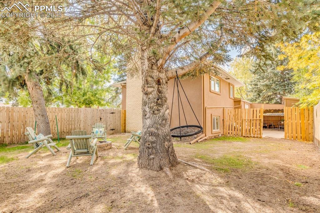 Image 40 of 47: Fenced backyard featuring an outdoor fire pit