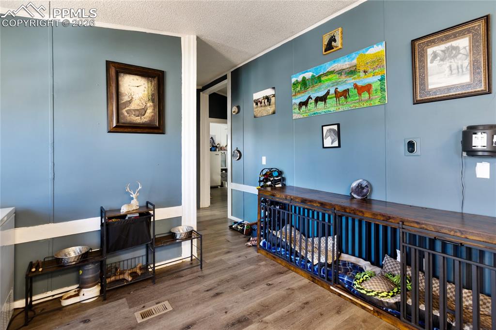 Image 8 of 27: The dining space with wood finished floors, and ornamental molding!