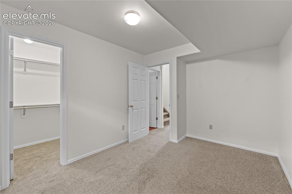 Image 31 of 43: Basement bedroom w/ walk-in closet