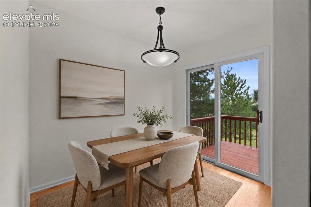 Image 8 of 43: Virtual Staged Eat-in dining space with walkout to deck