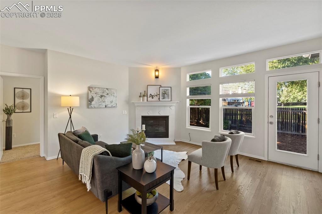 Image 10 of 39: Cozy and comfortable, the living room centers around a gas fireplace and na
