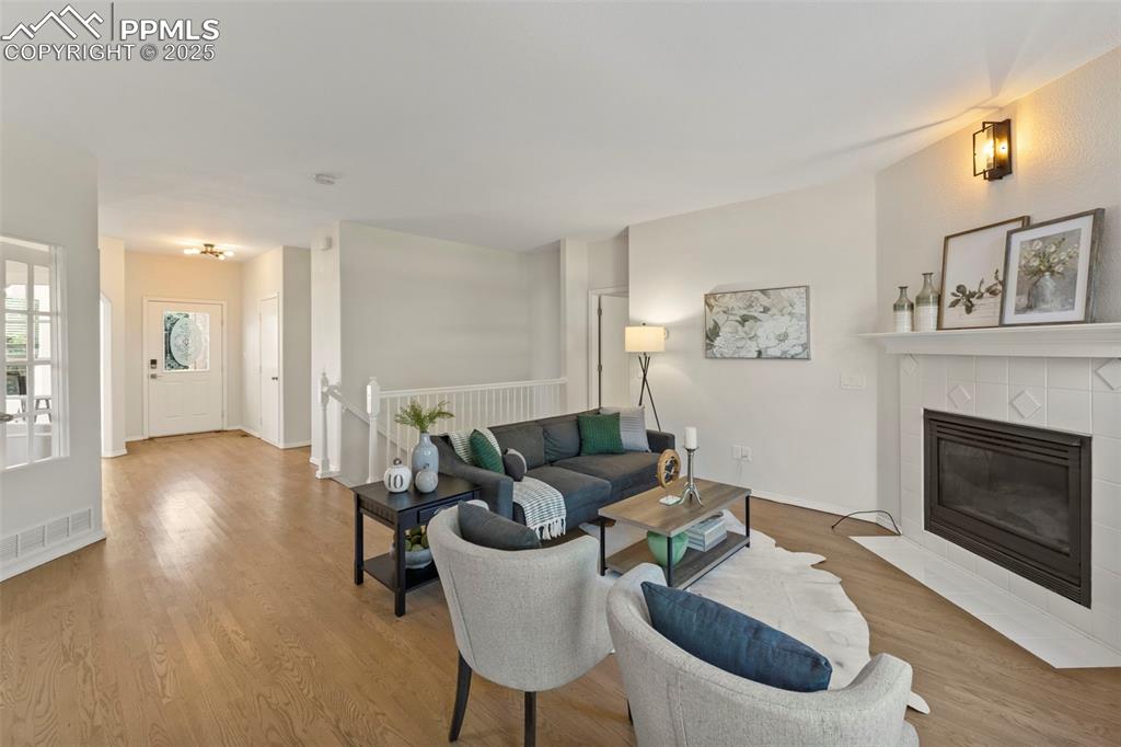 Image 11 of 39: Cozy and comfortable, the living room centers around a gas fireplace and na