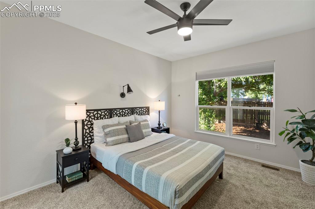 Image 14 of 39: Peaceful and private, the primary bedroom includes a walk-in closet and a f