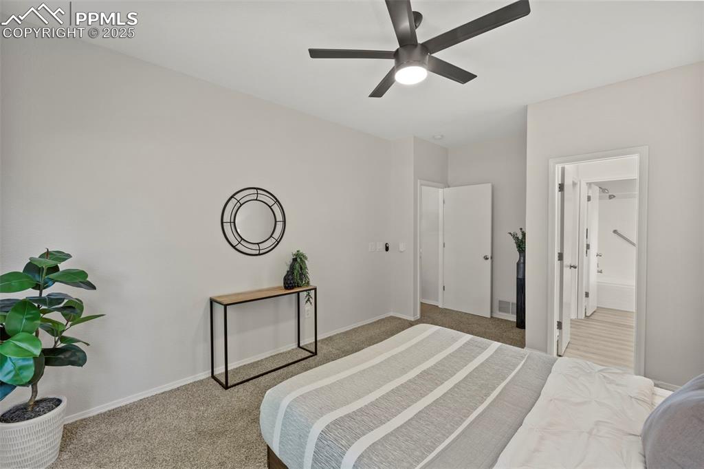 Image 15 of 39: Peaceful and private, the primary bedroom includes a walk-in closet and a f