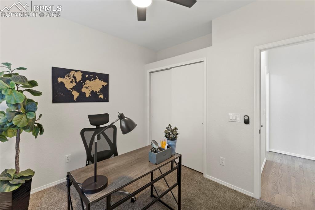 Image 20 of 39: Quiet and bright, the main-level office features hardwood flooring and make