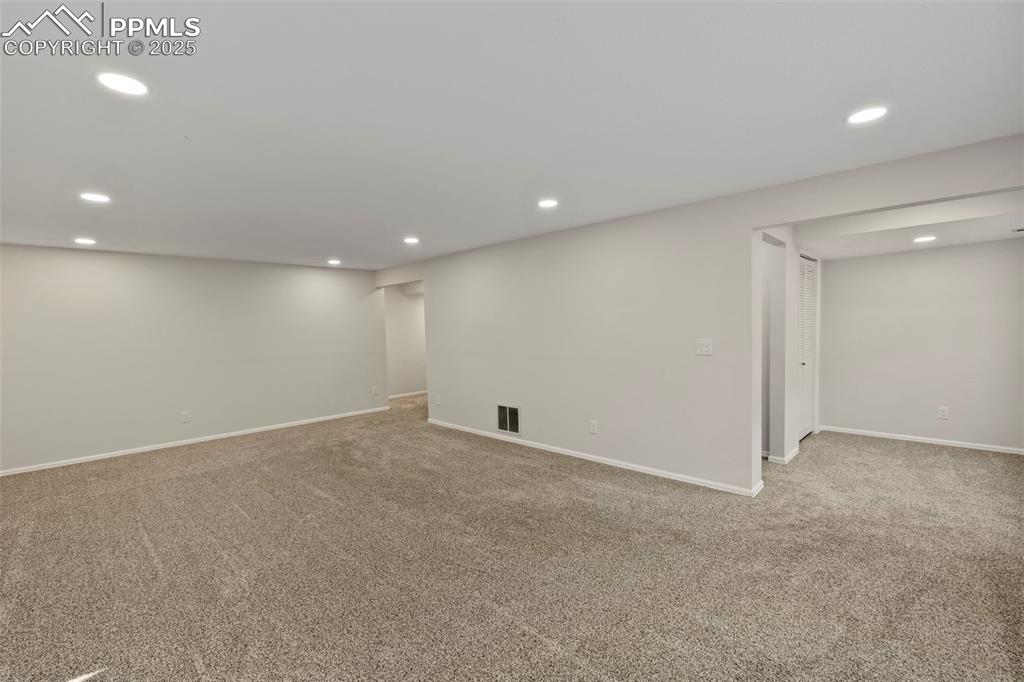 Image 24 of 39: The finished basement opens into a large family room, perfect for movie nig