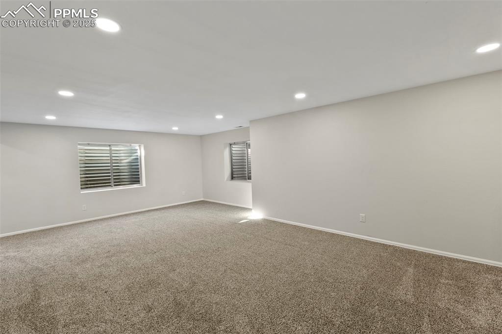 Image 26 of 39: The finished basement opens into a large family room, perfect for movie nig