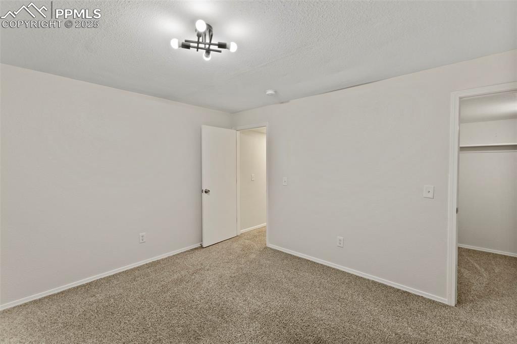 Image 31 of 39: Perfect for guests, teens, or home gym setups, the basement bedrooms feel p