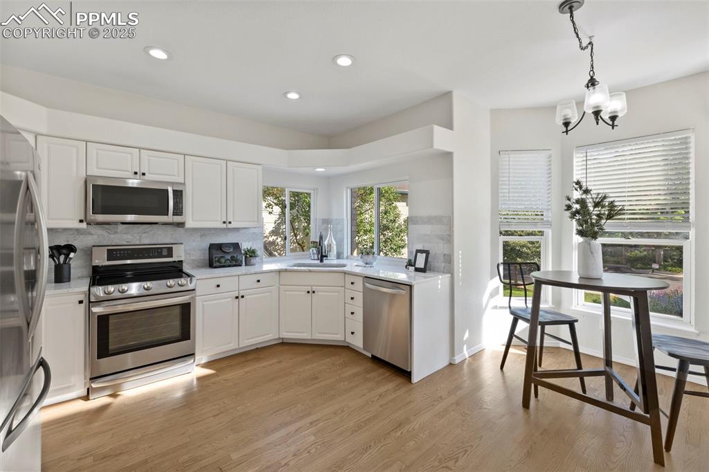 Image 4 of 39: Warm and efficient, the kitchen offers everything you need—plenty of prep s