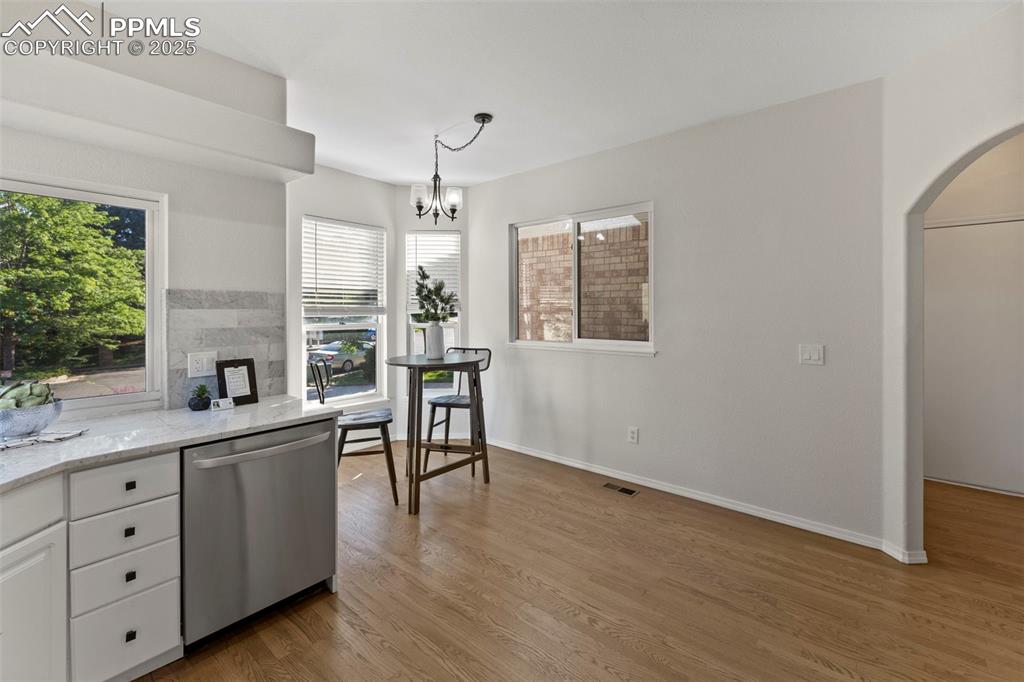 Image 6 of 39: Warm and efficient, the kitchen offers everything you need—plenty of prep s