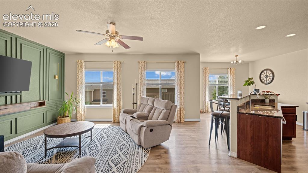 Image 12 of 41: Living area featuring a sage green accent wall with decorative molding and