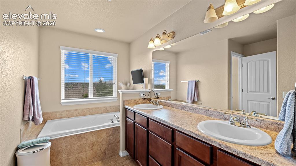 Image 16 of 41: Vaulted bedroom featuring carpet flooring, ceiling fan, and a single window