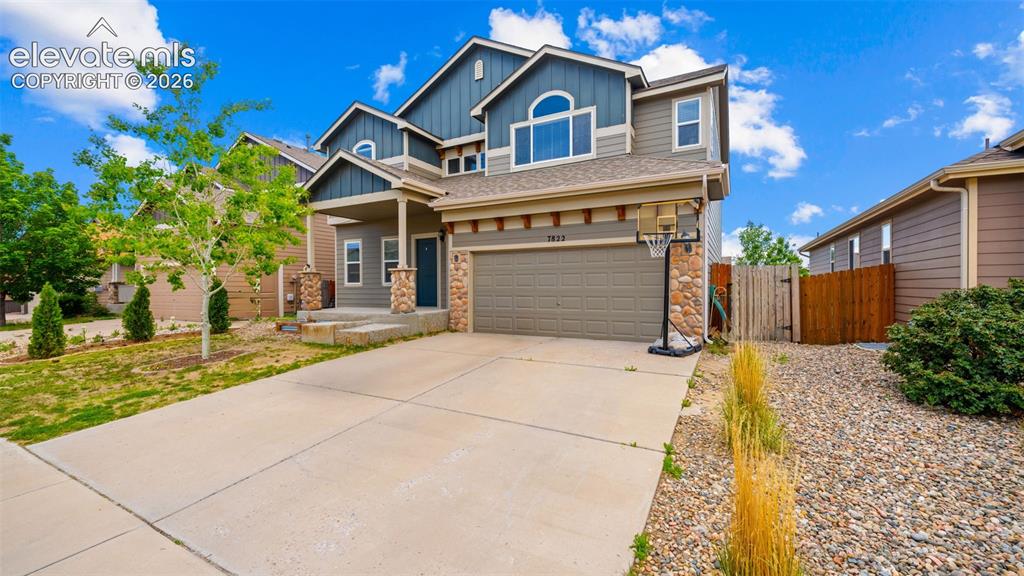 Image 2 of 41: Two-story residence featuring a three-car tandem garage, stone accents, cov