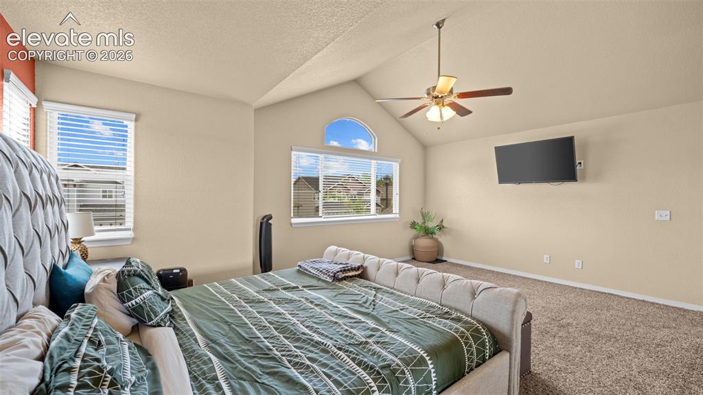 Image 22 of 41: Carpeted room featuring a ceiling fan with integrated lighting, a window wi