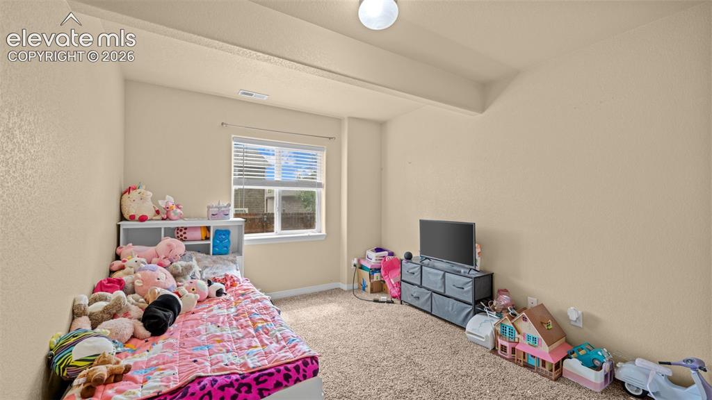 Image 23 of 41: Vaulted ceiling with a ceiling fan and light fixture