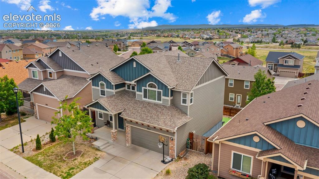 Image 29 of 41: Multi-level home featuring a light gray and blue exterior with gabled roofs