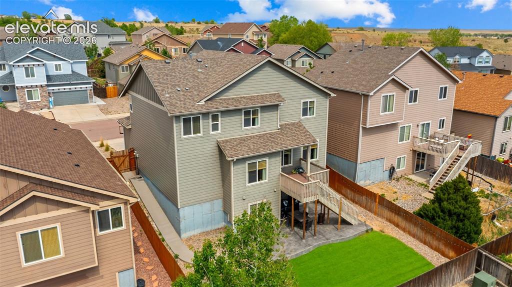 Image 31 of 41: Rear exterior featuring a multi-level deck, lower patio, and fenced yard wi