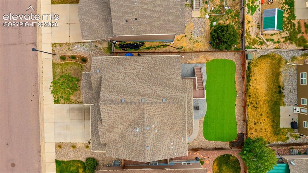 Image 36 of 41: Aerial perspective showcasing the backyard with artificial turf