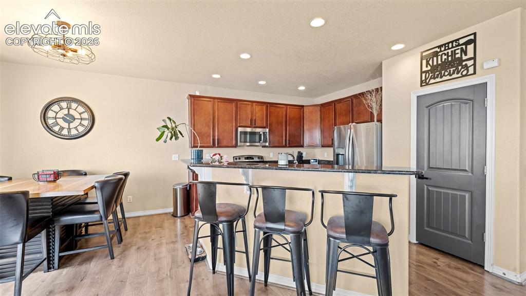 Image 6 of 41: Versatile room featuring light-toned walls, wood-finish flooring, and multi