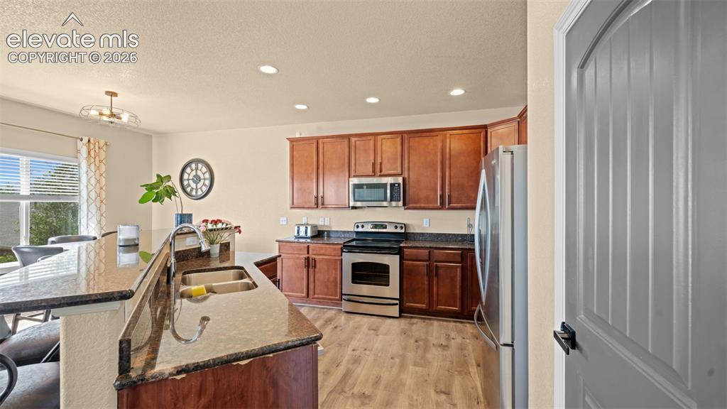 Image 7 of 41: Kitchen featuring wood-finish flooring, recessed lighting, and a breakfast