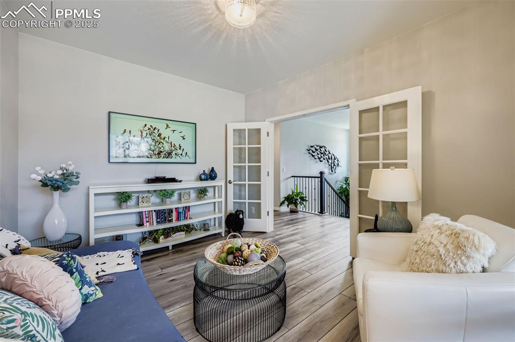 Image 12 of 50: Living area featuring wood finished floors and french doors
