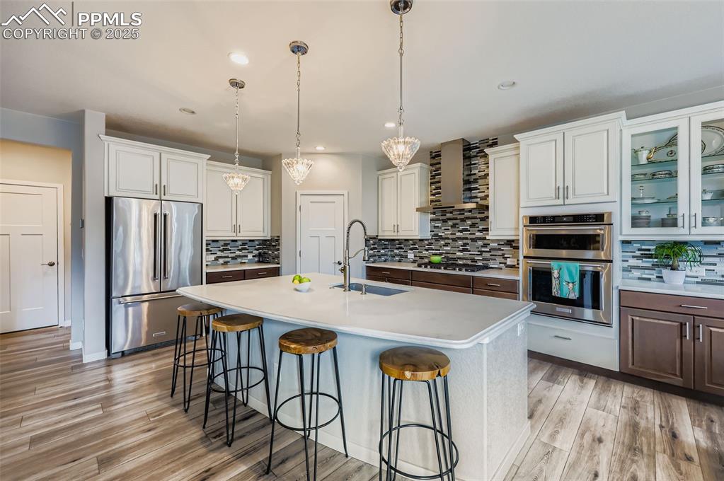 Image 14 of 50: Kitchen featuring appliances with stainless steel finishes, tasteful backsp