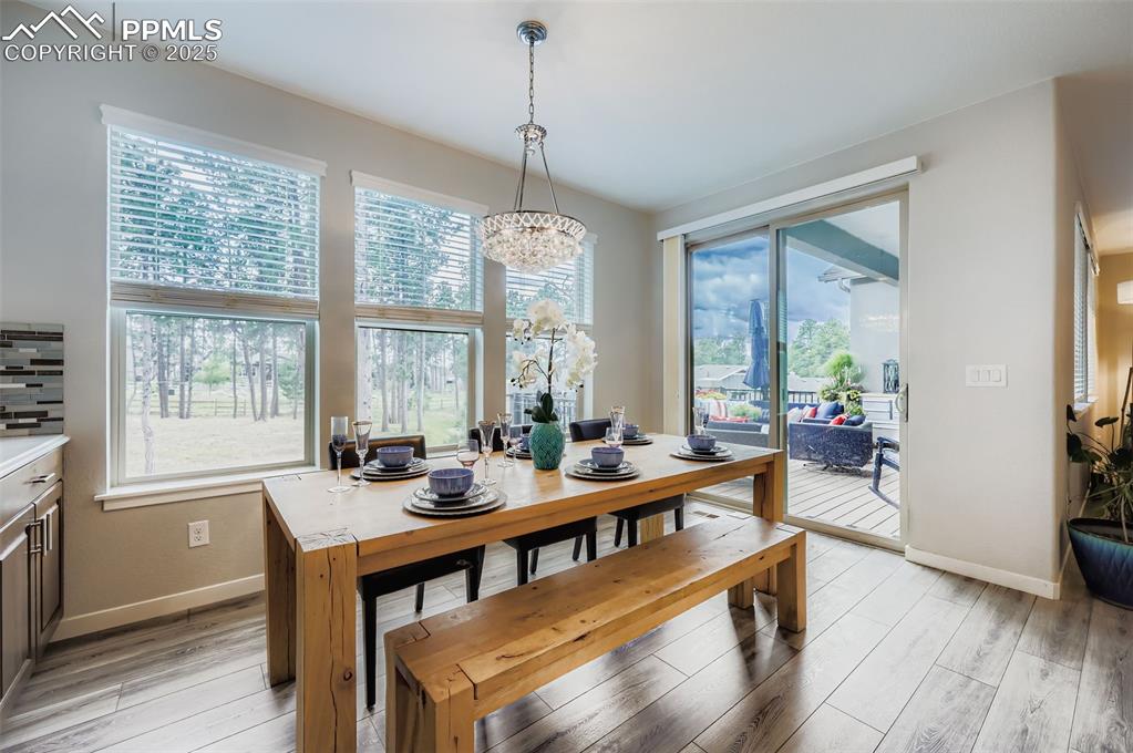 Image 18 of 50: Dining room featuring light wood-type flooring and a chandelier