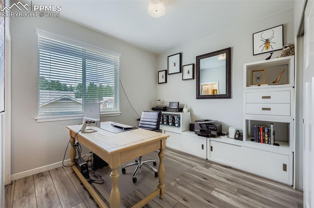 Image 25 of 50: Office space featuring light wood-style flooring and baseboards