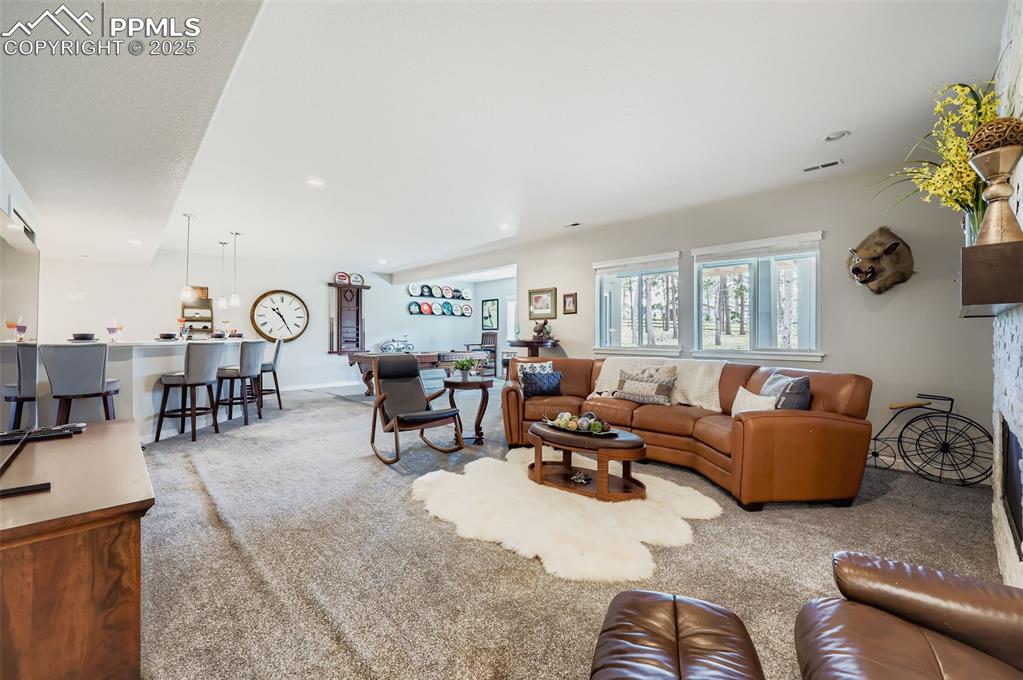 Image 29 of 50: Living area featuring light carpet and recessed lighting