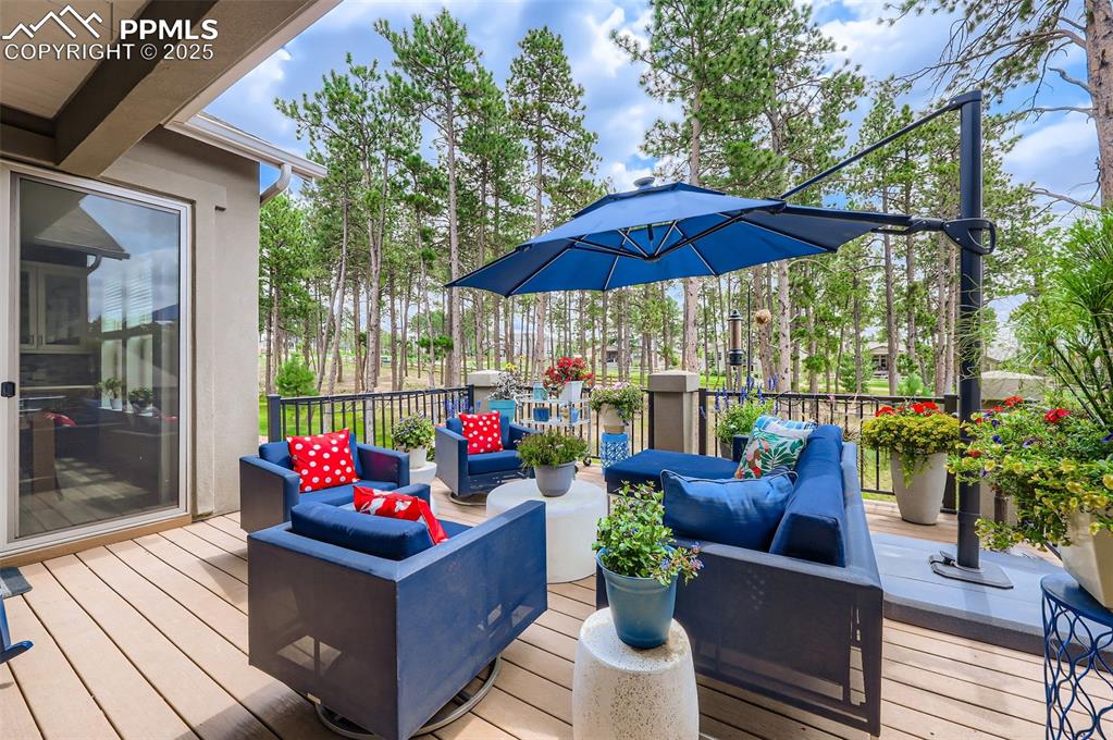 Image 47 of 50: Wooden terrace featuring an outdoor hangout area