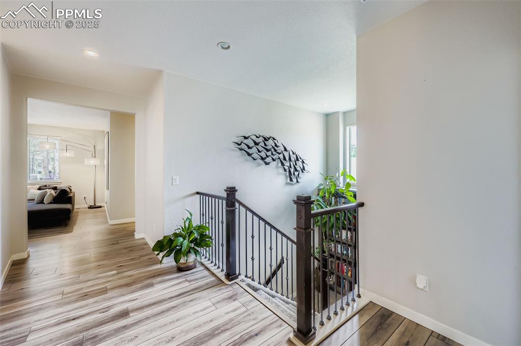 Image 7 of 50: Stairs featuring wood finished floors and recessed lighting