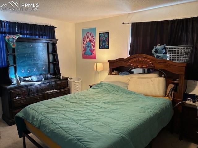 Image 7 of 17: Bedroom featuring carpet floors and a textured ceiling