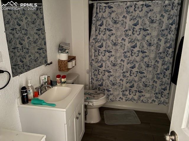 Image 8 of 17: Bathroom with a textured wall and vanity
