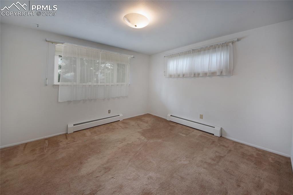 Image 21 of 37: Carpeted empty room featuring baseboard heating
