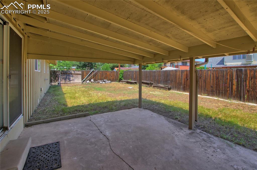 Image 31 of 37: Fenced backyard featuring a patio area